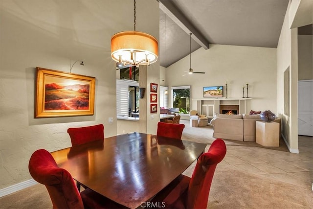 dining space with light carpet, ceiling fan with notable chandelier, high vaulted ceiling, and beamed ceiling