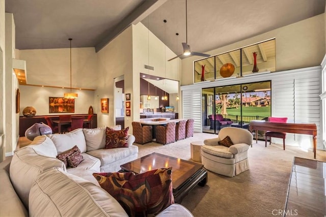 carpeted living room featuring a towering ceiling