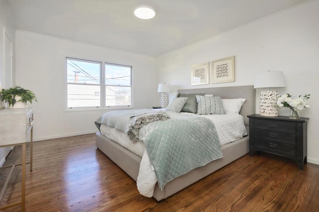 bedroom with dark wood-type flooring