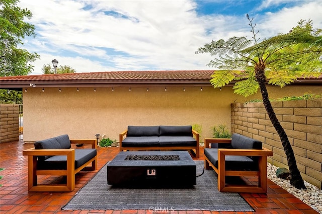 view of patio featuring an outdoor living space with a fire pit