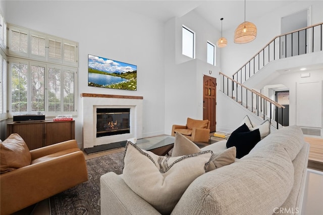 living room featuring hardwood / wood-style flooring and a high ceiling