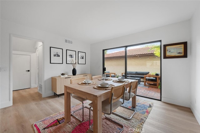 dining area featuring light wood-type flooring