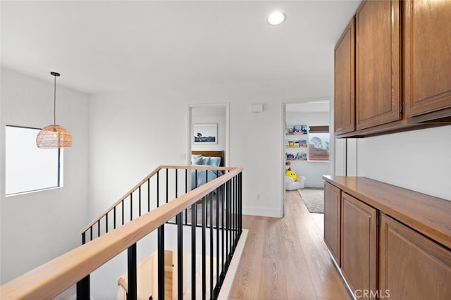 hallway with light hardwood / wood-style floors