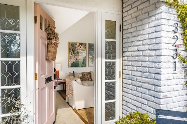 doorway to outside with light tile patterned floors