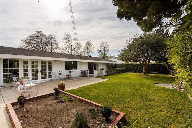 view of yard featuring french doors and a patio area
