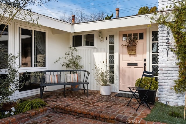 entrance to property featuring a patio