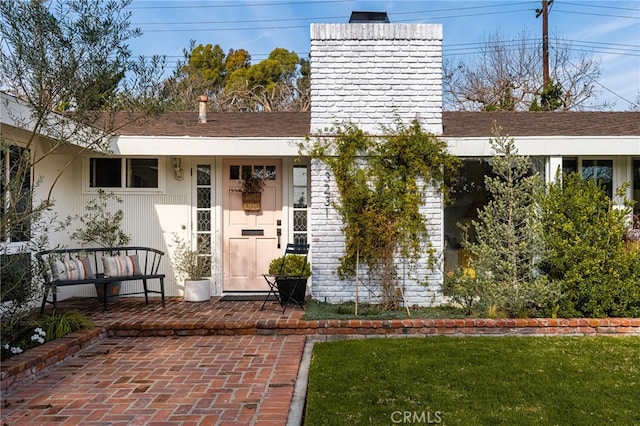 property entrance featuring a chimney