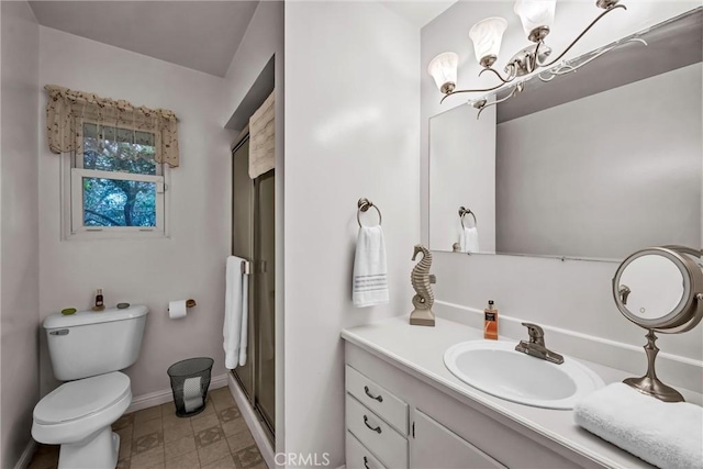 bathroom featuring walk in shower, vanity, toilet, and a notable chandelier