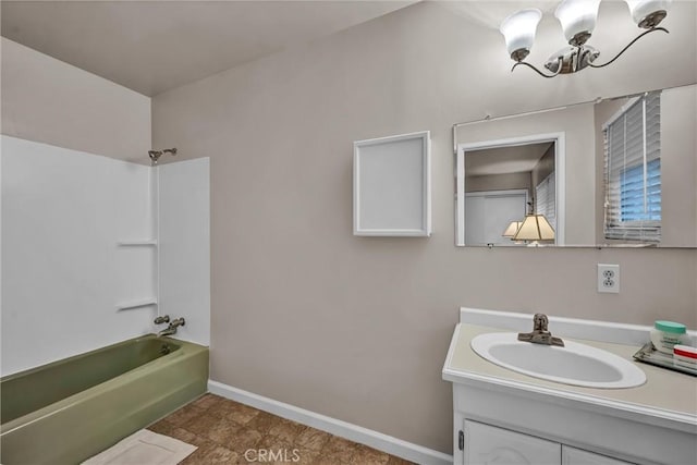 bathroom featuring  shower combination, a chandelier, and vanity