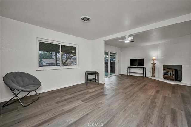 sitting room with hardwood / wood-style floors and ceiling fan