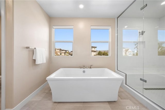 bathroom with tile patterned flooring and separate shower and tub