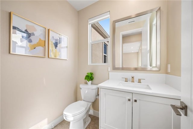 bathroom with tile patterned floors, vanity, and toilet