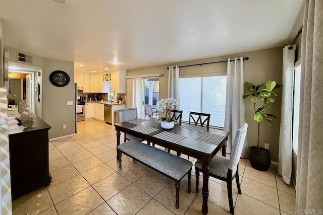 dining space featuring light tile patterned floors