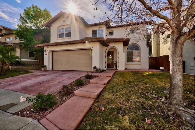 mediterranean / spanish-style house featuring a garage and a front lawn