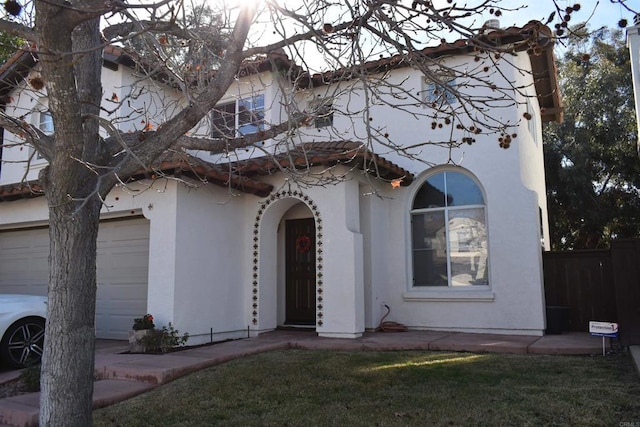 view of front facade featuring a garage and a front lawn