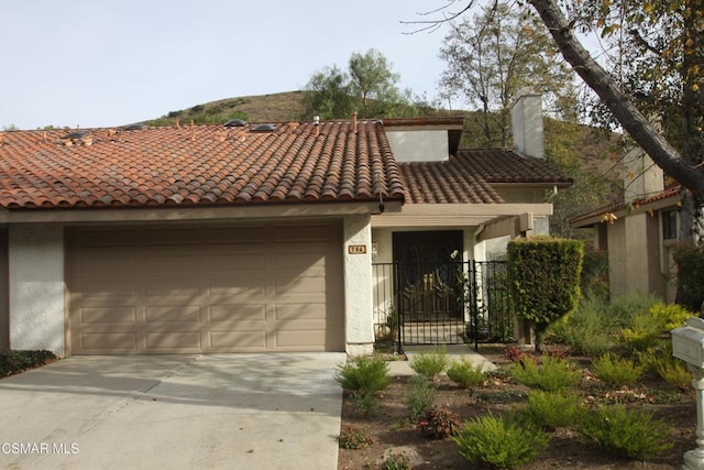 mediterranean / spanish-style home featuring a garage