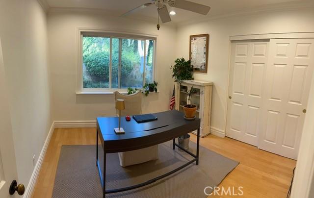 office area with crown molding, hardwood / wood-style flooring, and ceiling fan