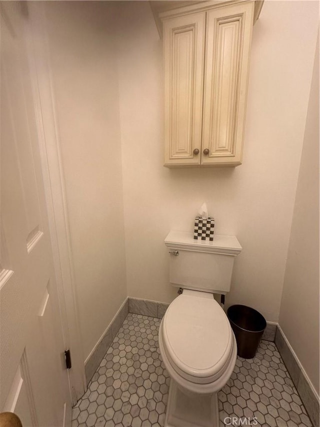 bathroom with tile patterned flooring and toilet