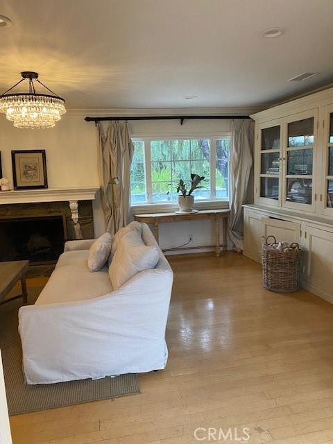 interior space featuring a notable chandelier and light wood-type flooring