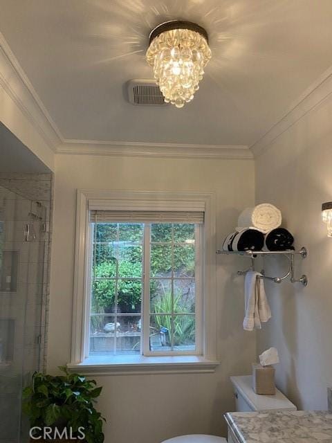 bathroom featuring ornamental molding, vanity, a notable chandelier, and a shower with shower door