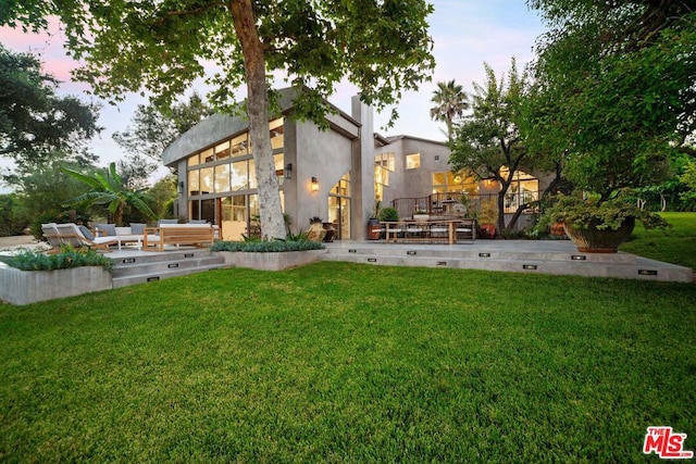 yard at dusk featuring a patio