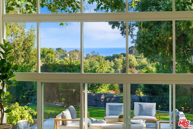 unfurnished sunroom with a healthy amount of sunlight and a water view