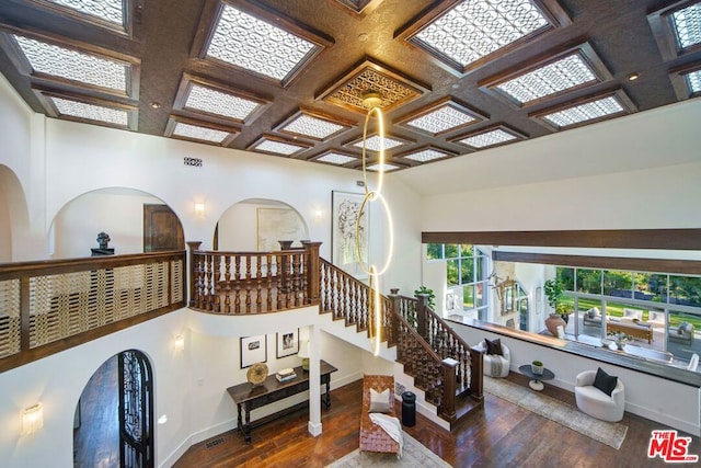 interior space featuring dark hardwood / wood-style flooring and coffered ceiling