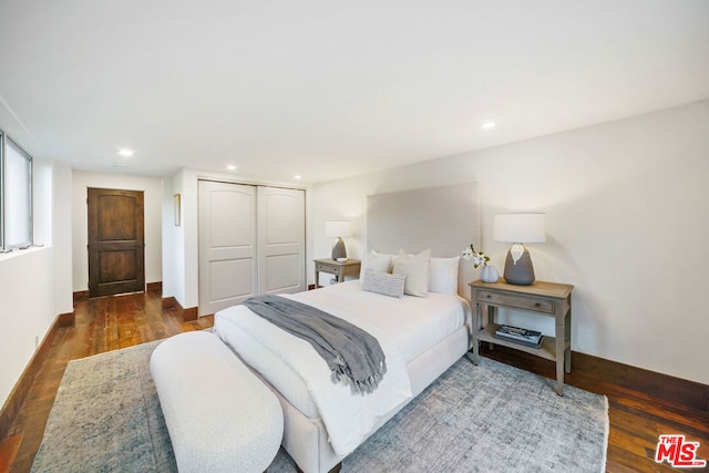 bedroom featuring a closet and dark hardwood / wood-style floors