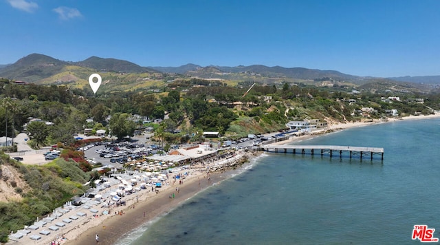 bird's eye view with a view of the beach and a water and mountain view