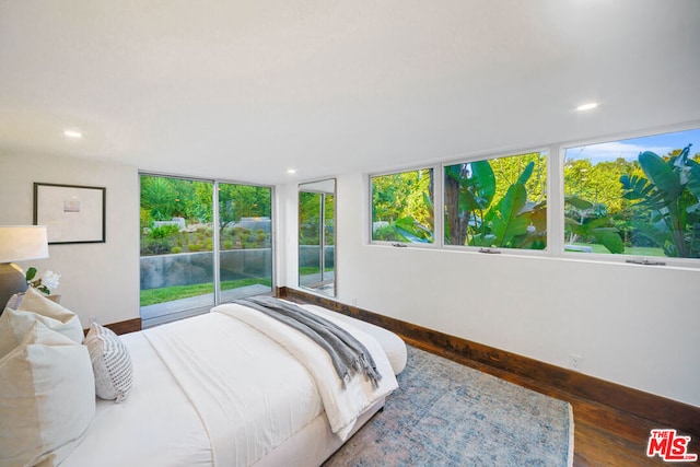 bedroom featuring dark wood-type flooring and access to outside