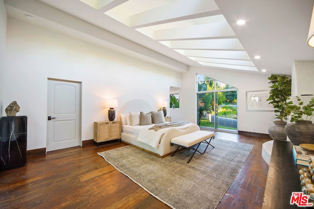 bedroom featuring dark hardwood / wood-style floors, access to outside, and high vaulted ceiling