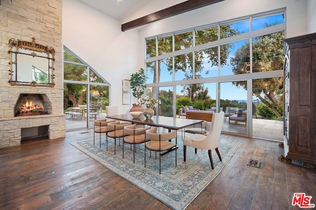 dining space with hardwood / wood-style flooring, plenty of natural light, and high vaulted ceiling