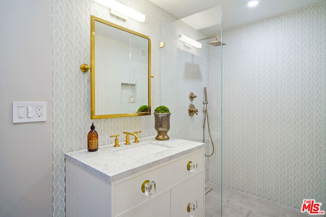 bathroom with vanity and a shower