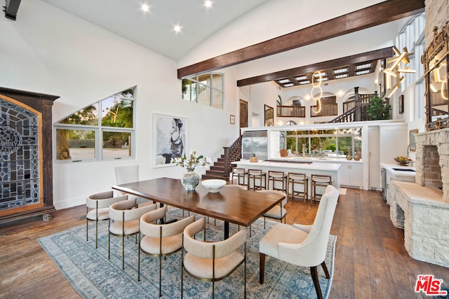 dining space with vaulted ceiling, a fireplace, and dark hardwood / wood-style flooring