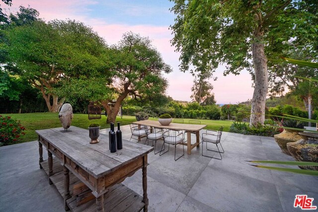 patio terrace at dusk with a yard