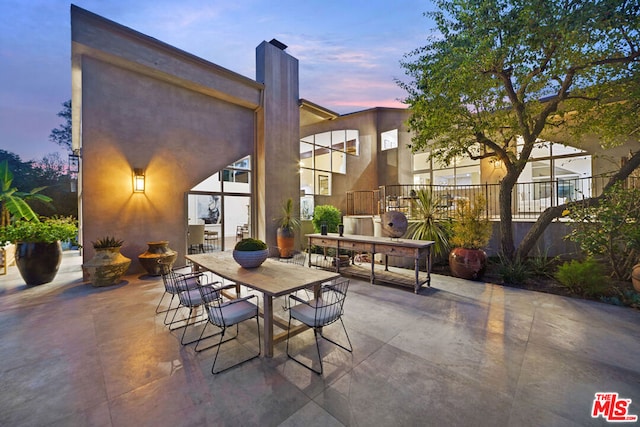 view of patio terrace at dusk