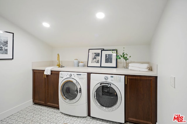 clothes washing area featuring cabinets, washing machine and dryer, and sink