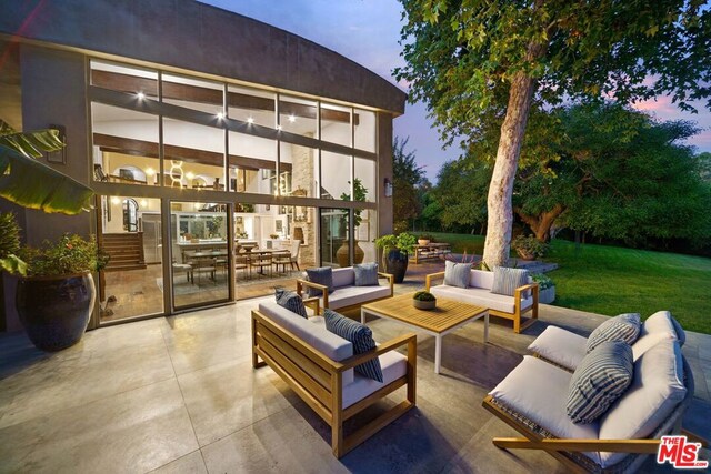 patio terrace at dusk with an outdoor living space