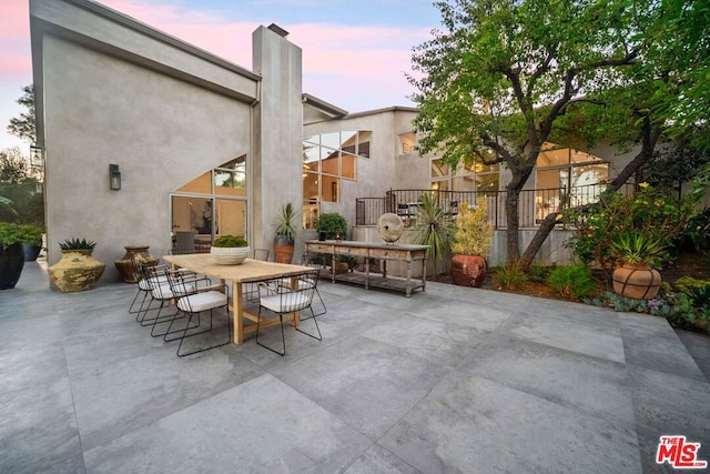 view of patio terrace at dusk