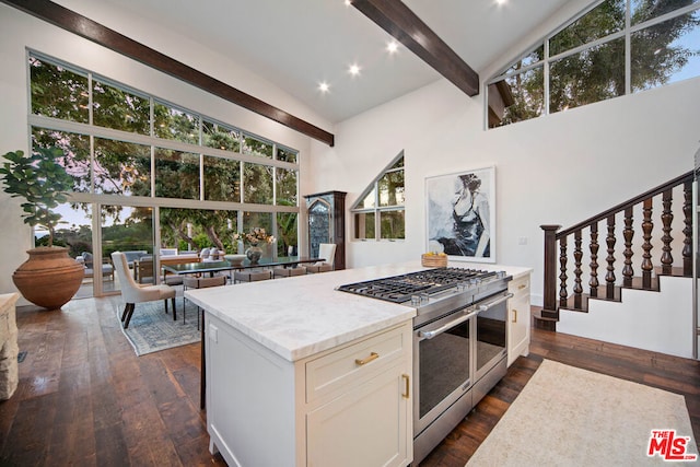 kitchen with high vaulted ceiling, light stone countertops, dark hardwood / wood-style flooring, beamed ceiling, and range with two ovens