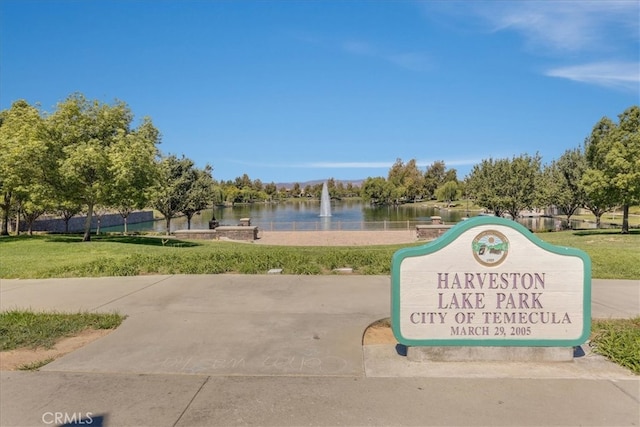 view of property's community featuring a water view and a lawn