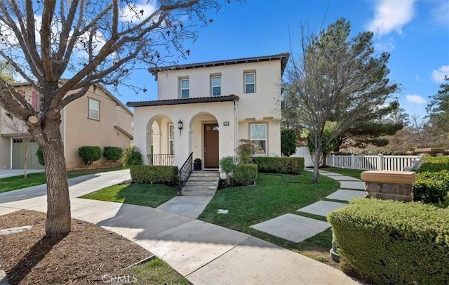 mediterranean / spanish home featuring a front yard