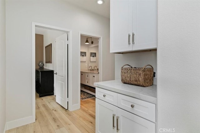 interior space with sink and light hardwood / wood-style flooring