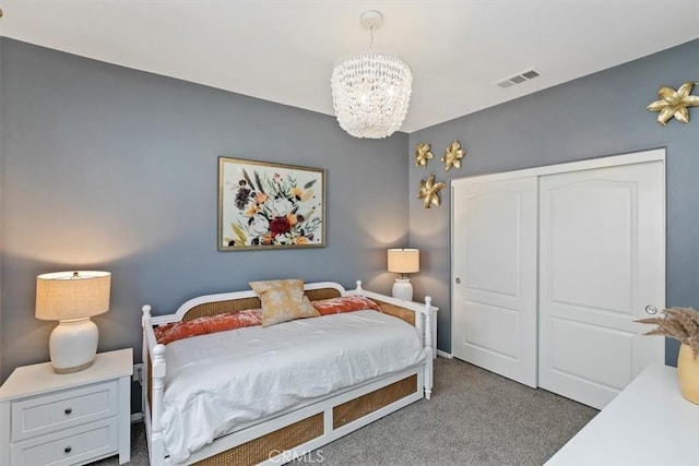 carpeted bedroom with an inviting chandelier and a closet