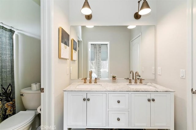 bathroom with vanity and toilet