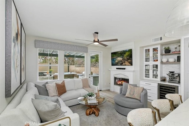 sunroom featuring wine cooler and ceiling fan