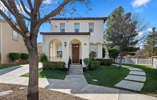 mediterranean / spanish house featuring a front yard