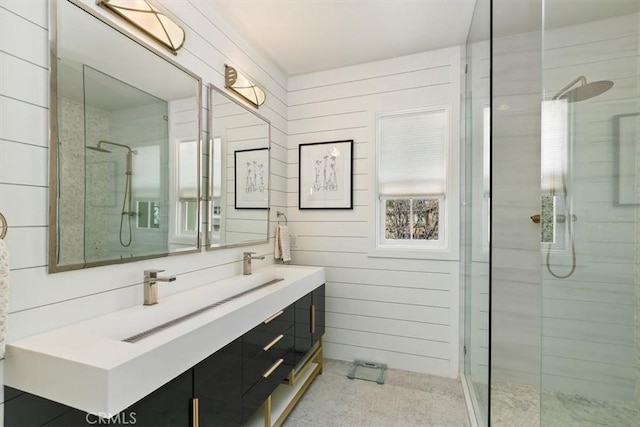 bathroom featuring a tile shower, vanity, and wooden walls