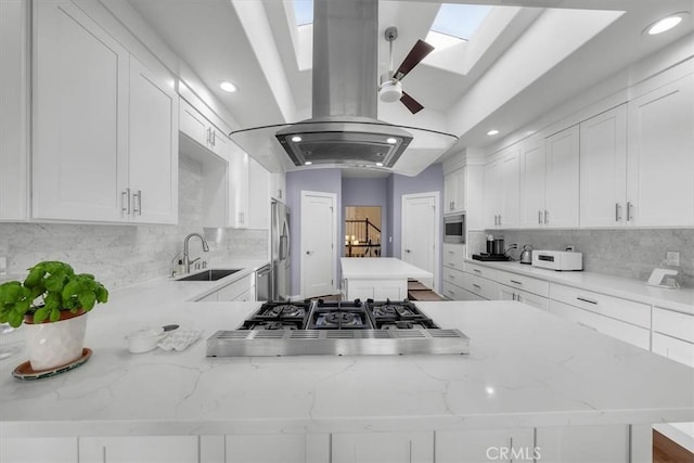 kitchen with sink, white cabinets, and kitchen peninsula