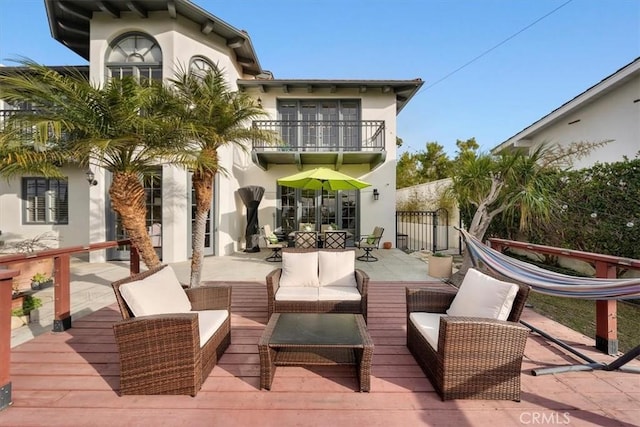 back of house with an outdoor hangout area, a balcony, and a patio area